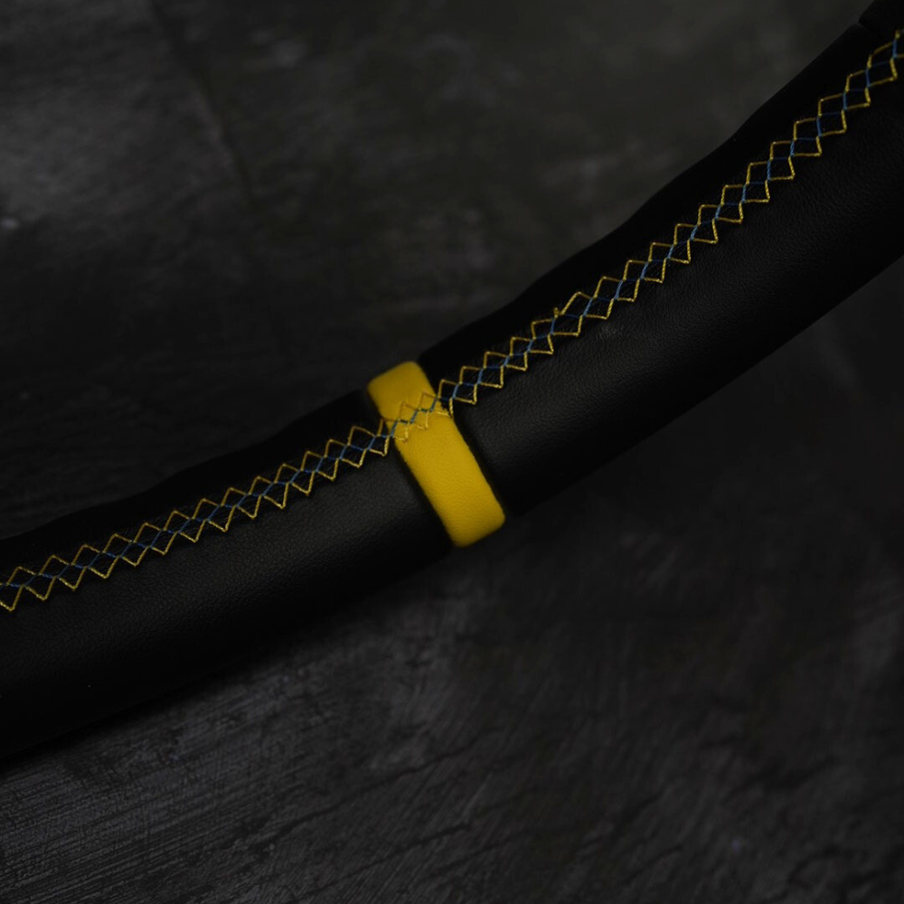 Yellow contrast stitching and center stripe on a leather steering wheel