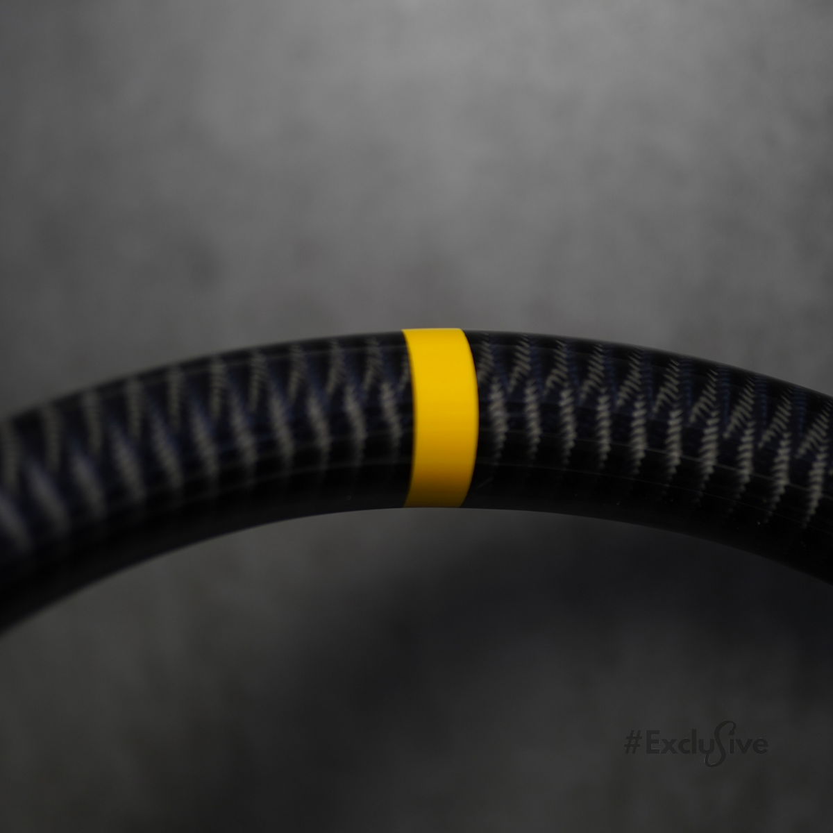 Gloss carbon fiber steering wheel rim with yellow center stripe