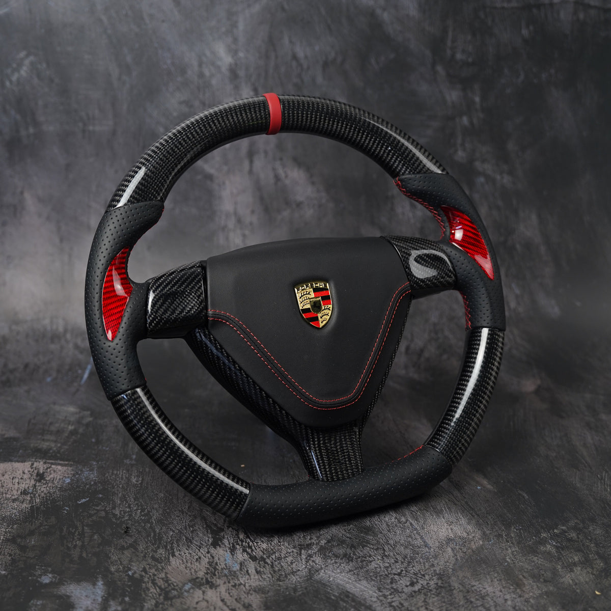 Custom Porsche 911 steering wheel in carbon fiber with red accents