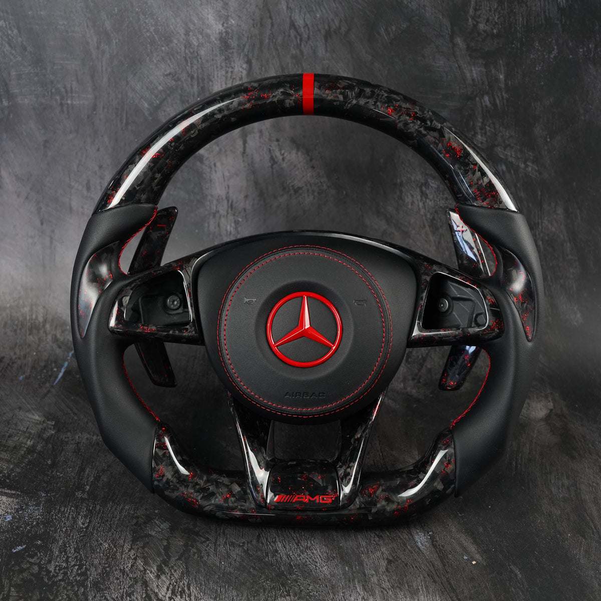 Custom Mercedes-AMG steering wheel in forged carbon with red center stripe