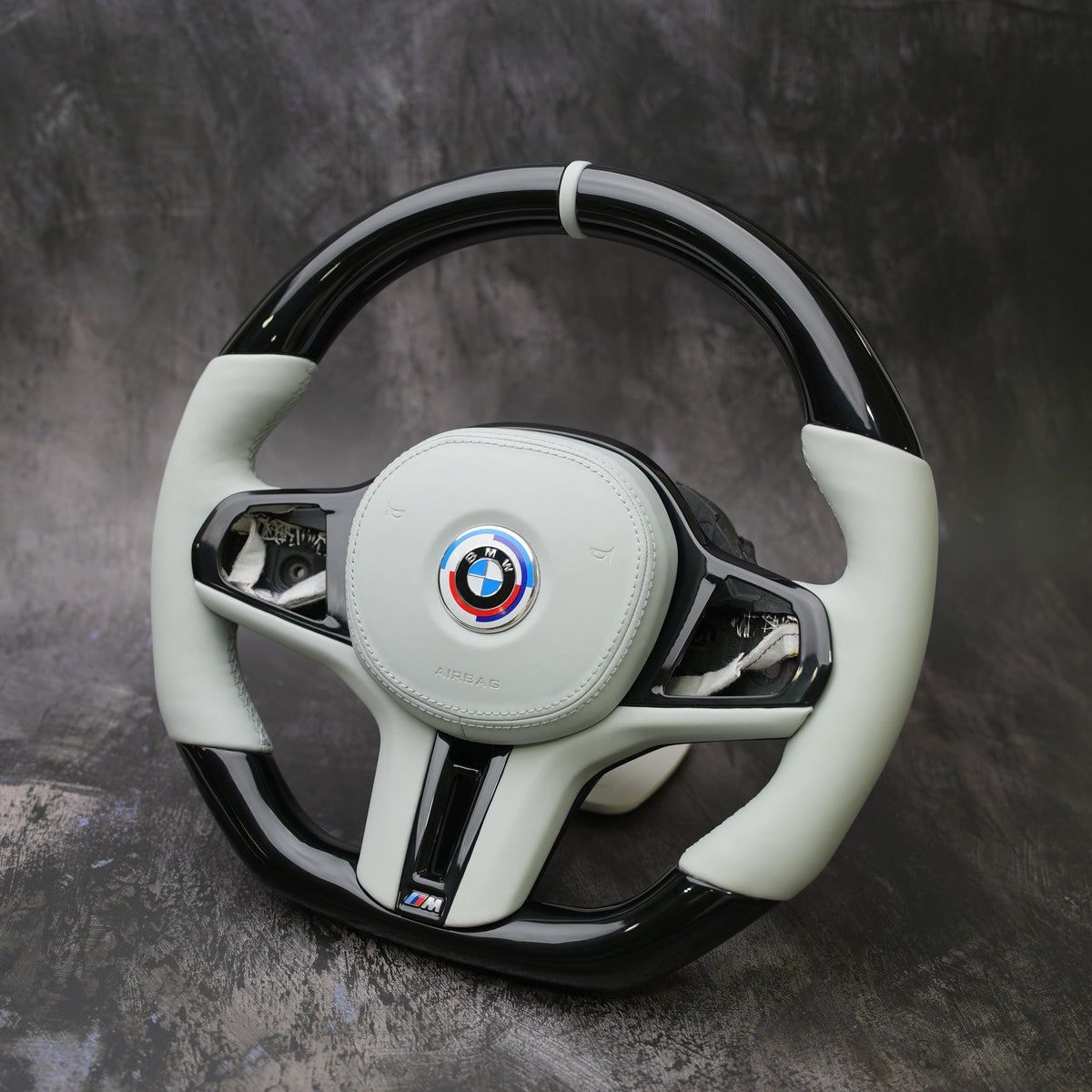 Custom BMW M steering wheel in white leather and carbon fiber